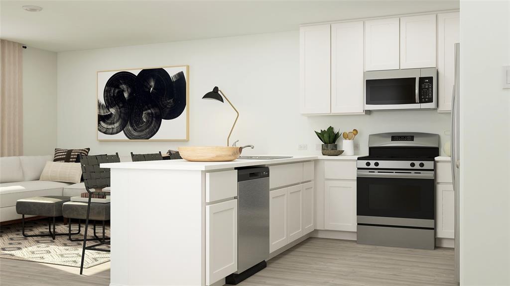 a kitchen with a sink and a stove top oven with wooden floor