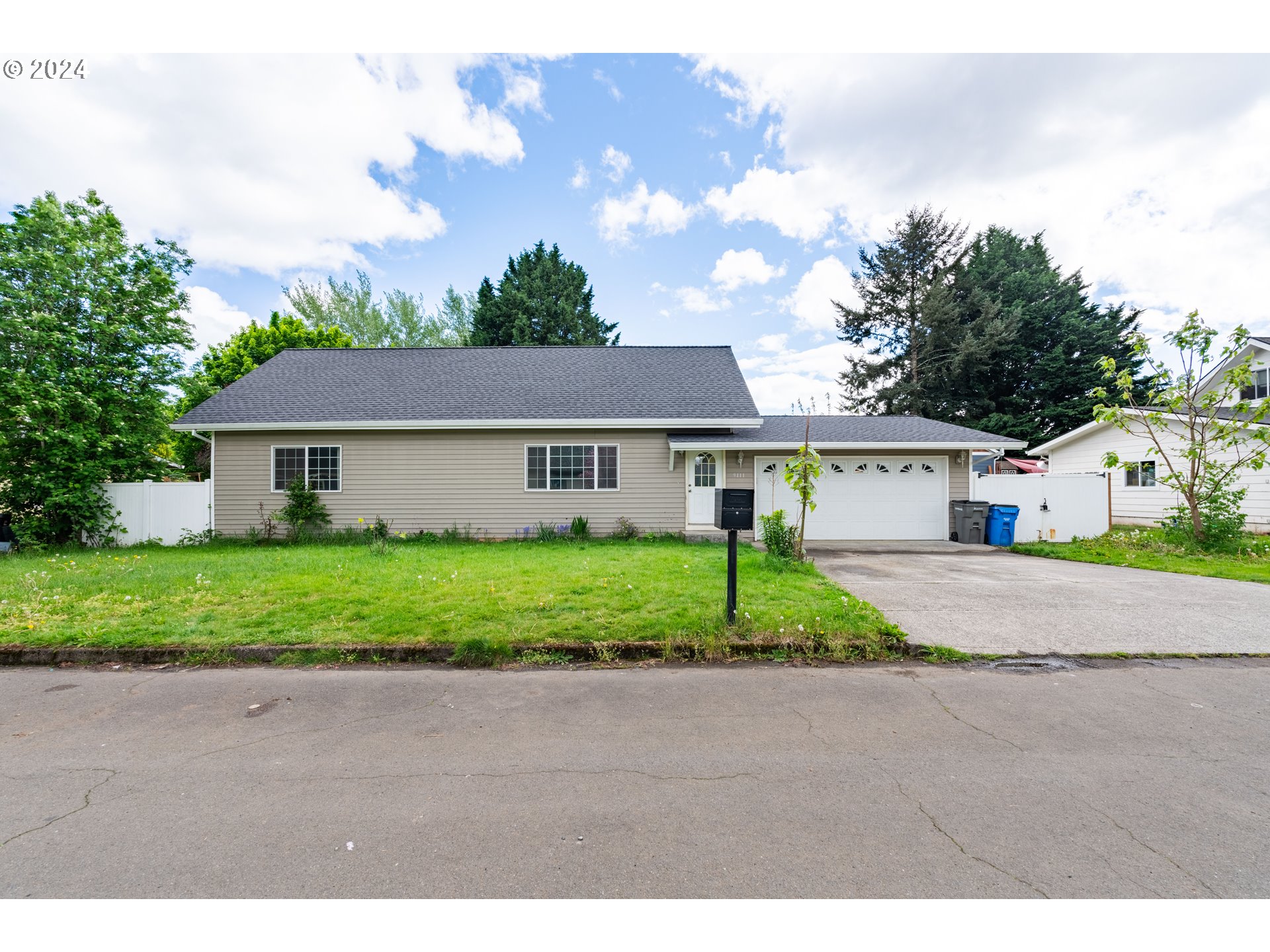 a front view of house with yard and green space