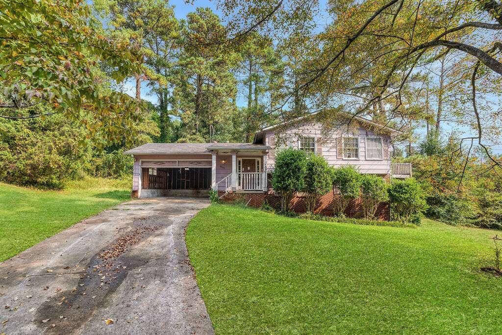 a front view of a house with yard and green space