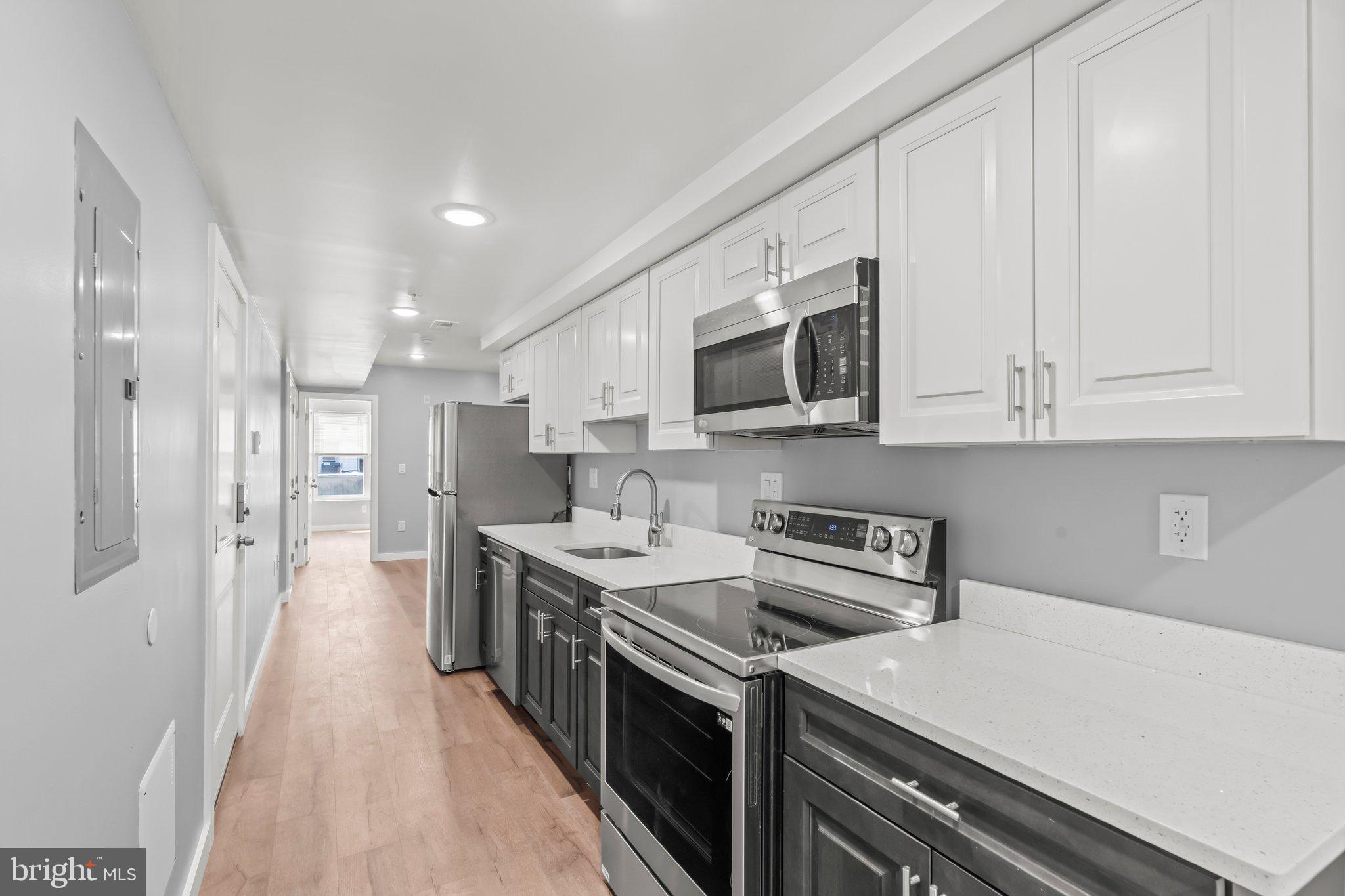 a kitchen with a sink a stove and cabinets