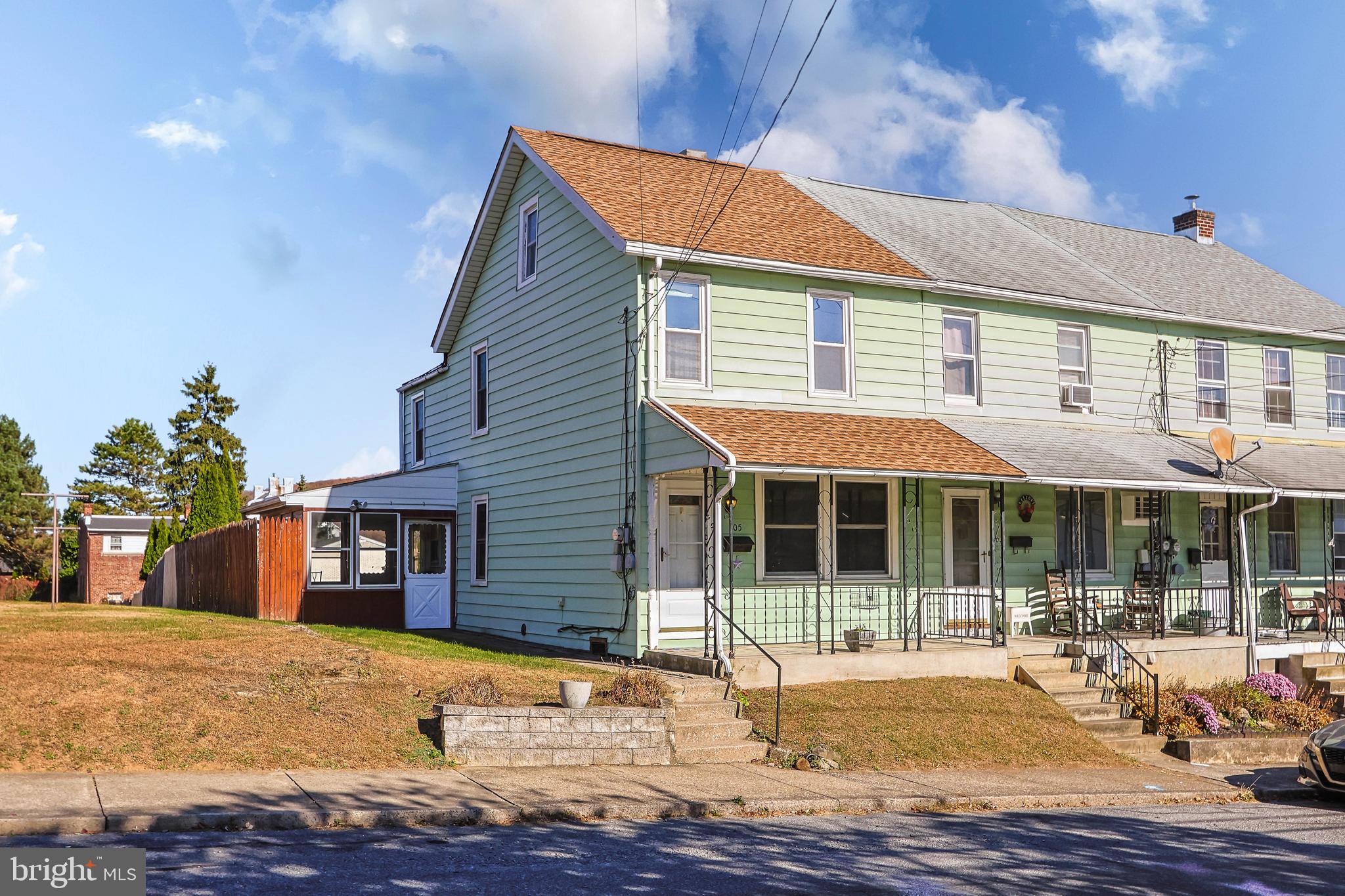 a front view of a house with a yard and seating space