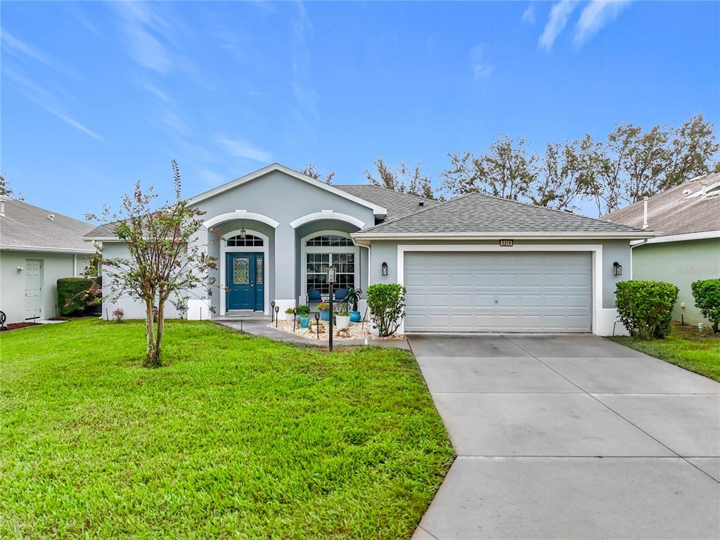 a front view of a house with a yard and garage