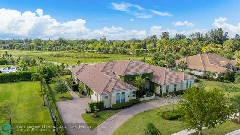 an aerial view of a house with garden space and lake view