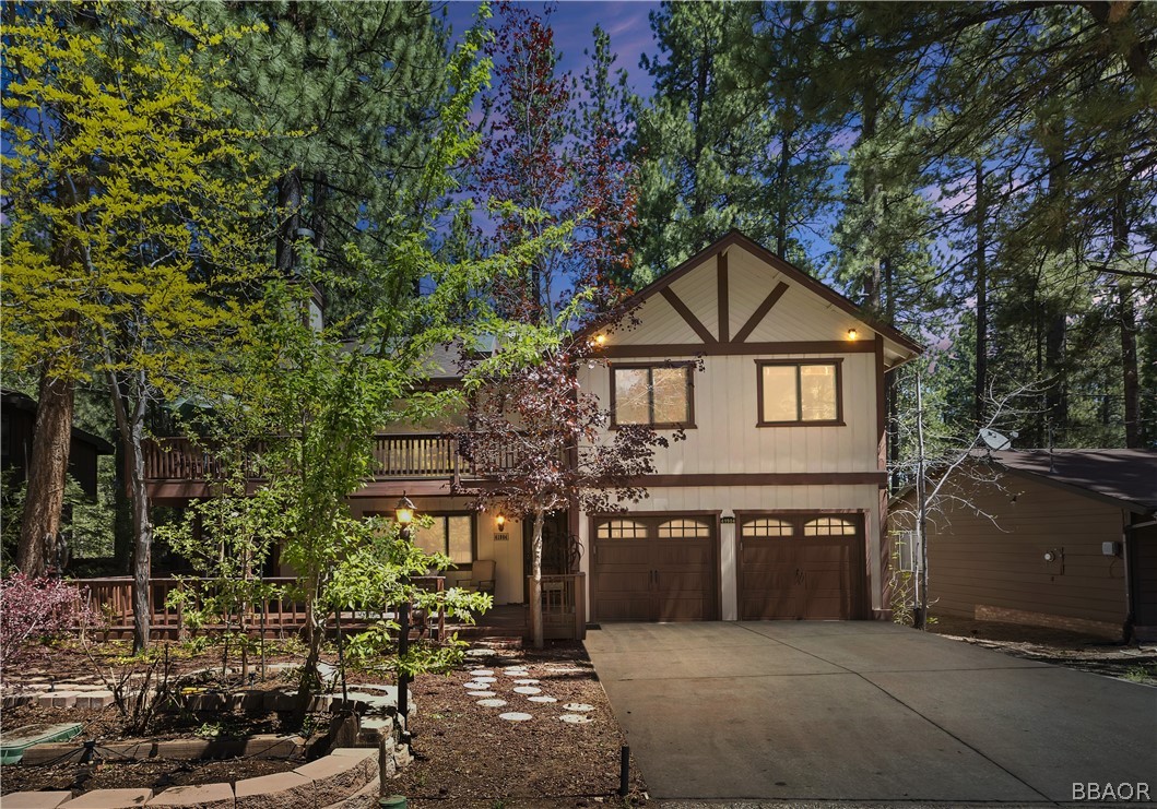 a front view of a house with yard and trees