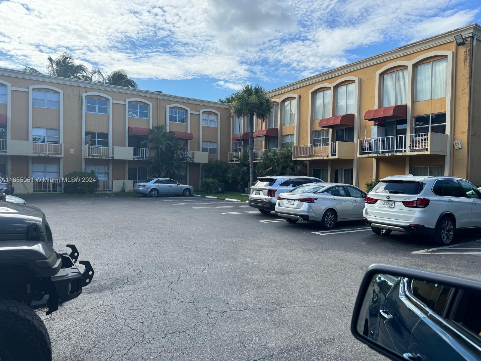 a view of a cars park in front of a house