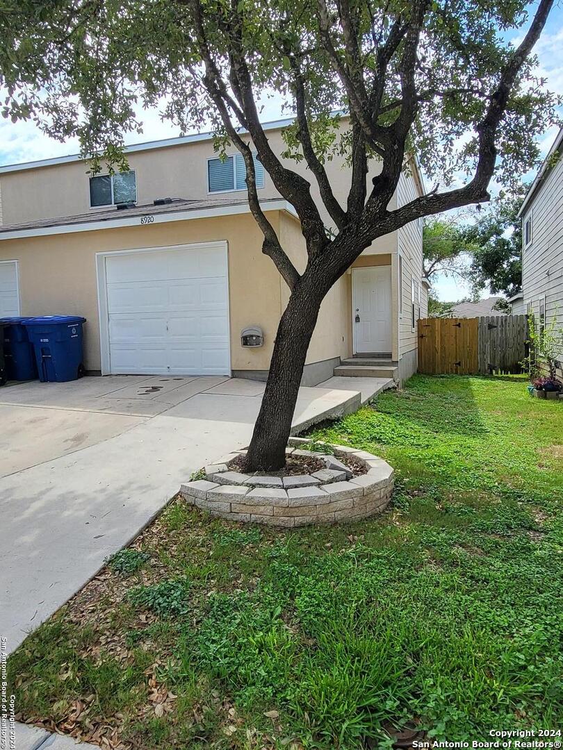 a view of a house with a backyard