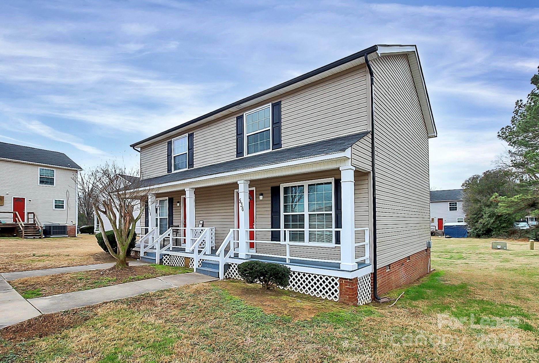 a front view of a house with a yard outdoor seating and garage