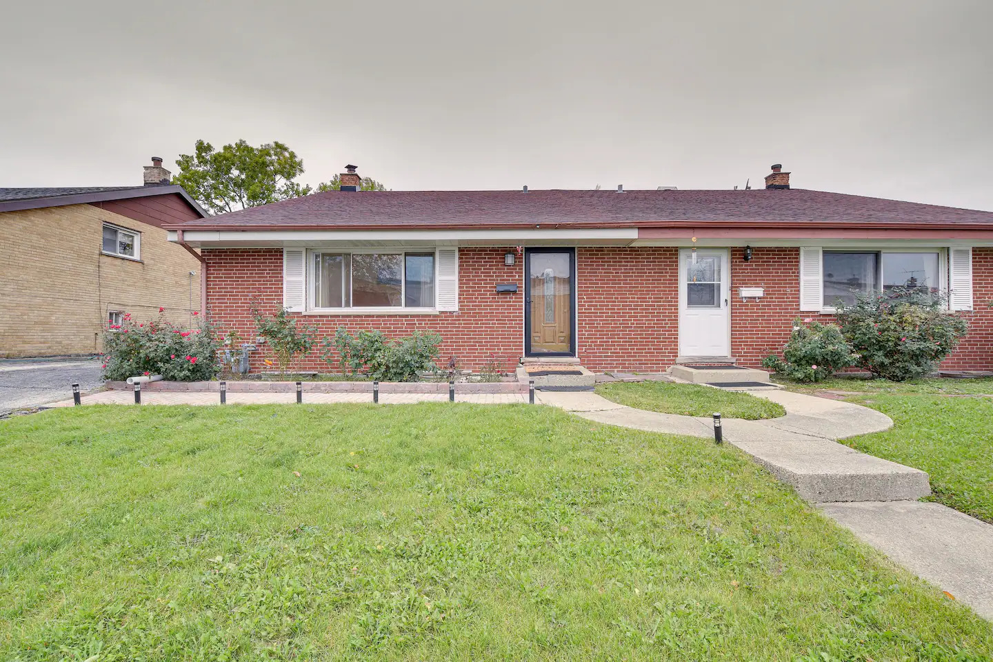 a front view of house with yard and green space