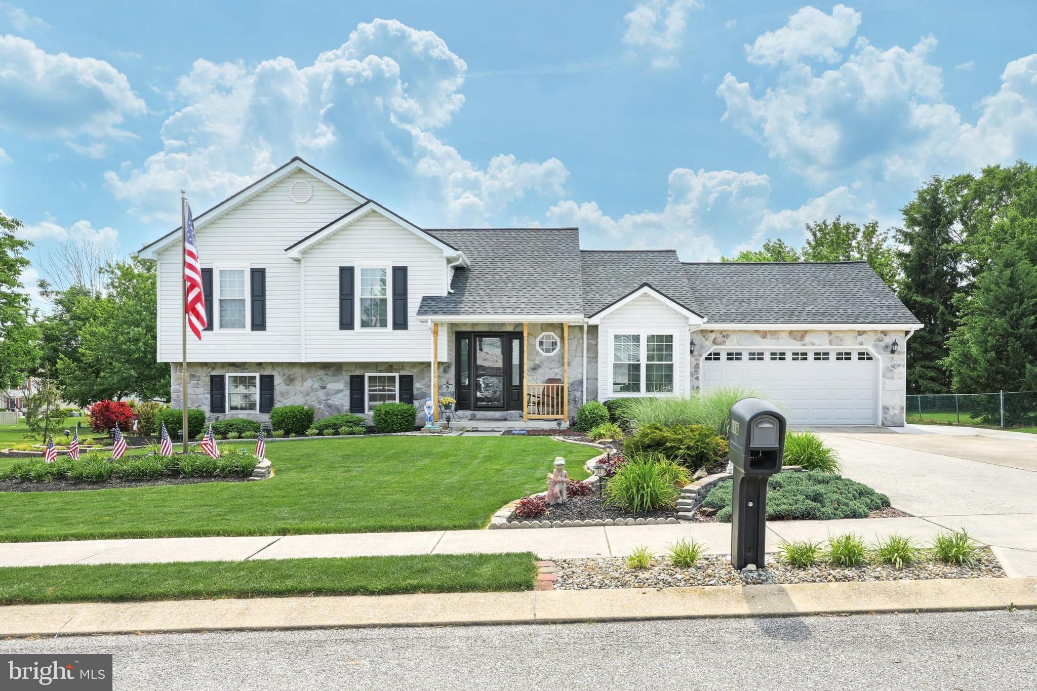 a view of a house with a yard and potted plants