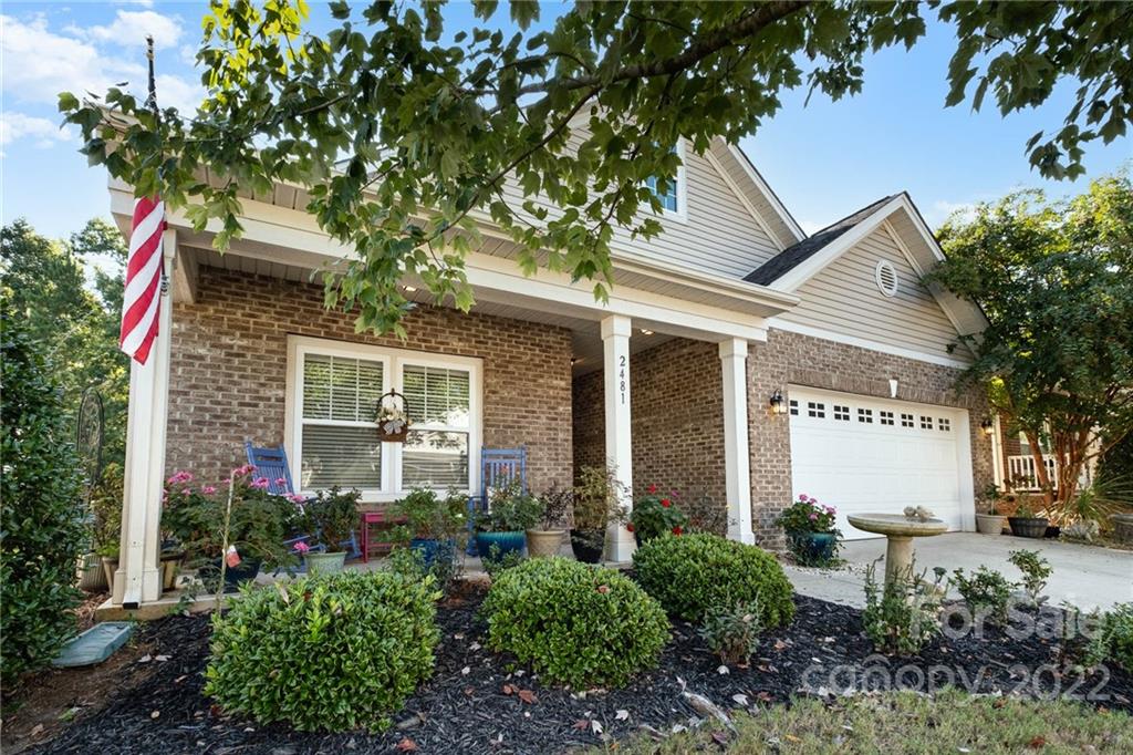 a front view of a house with garden