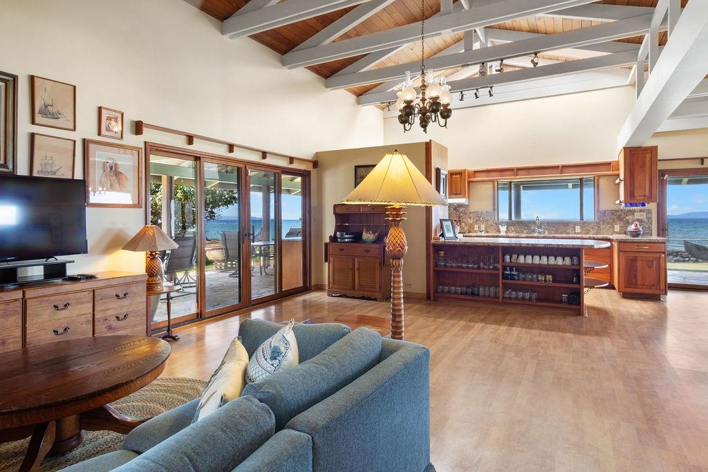 a living room with furniture a flat screen tv and next to a window