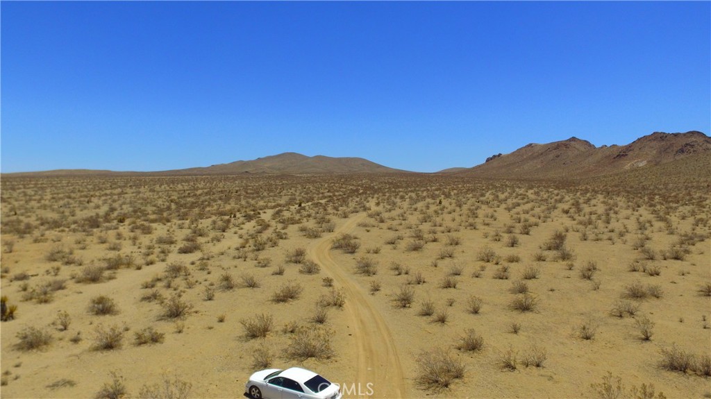 a view of a large mountain with mountains in the background