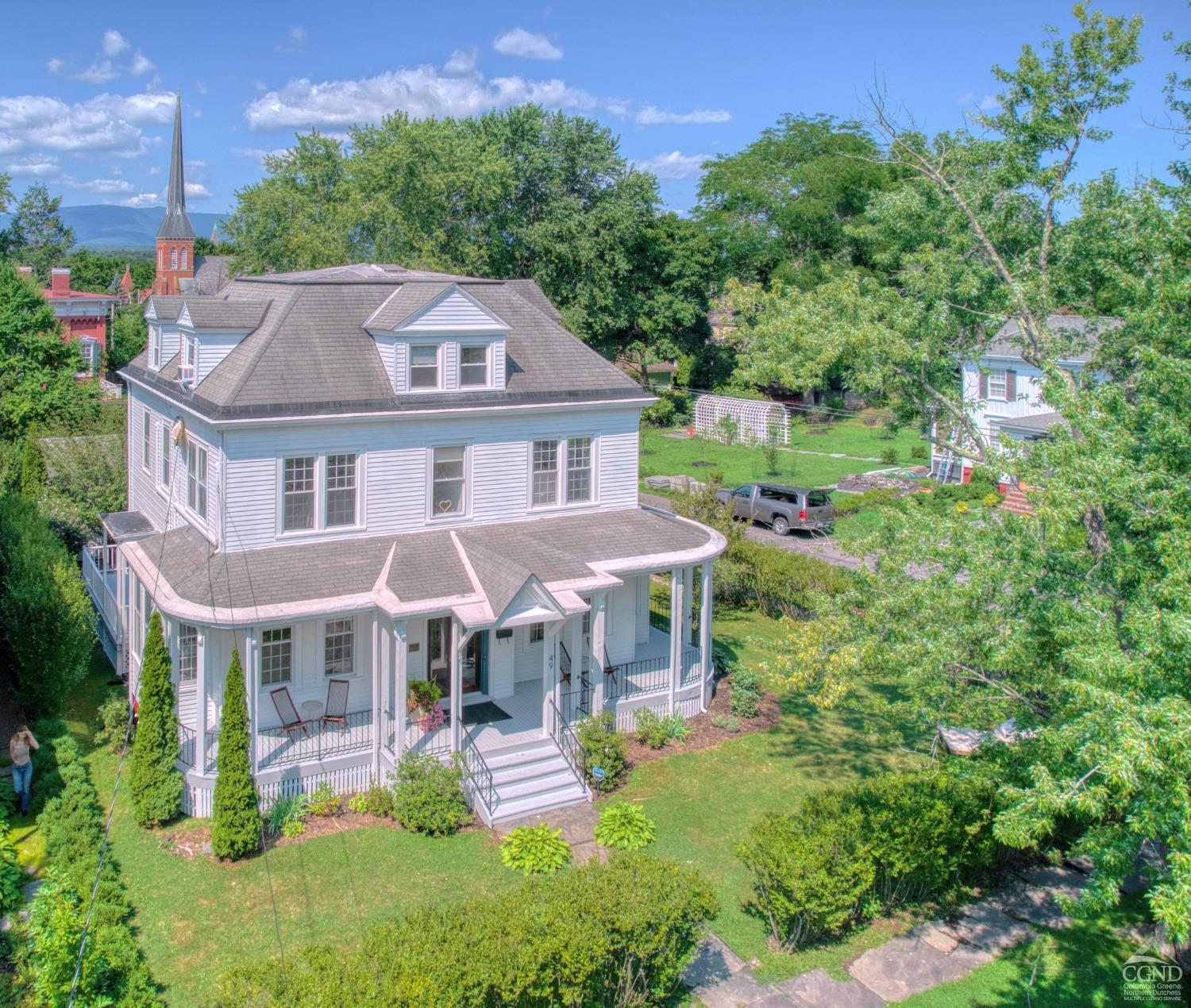 a aerial view of a house with a yard table and chairs