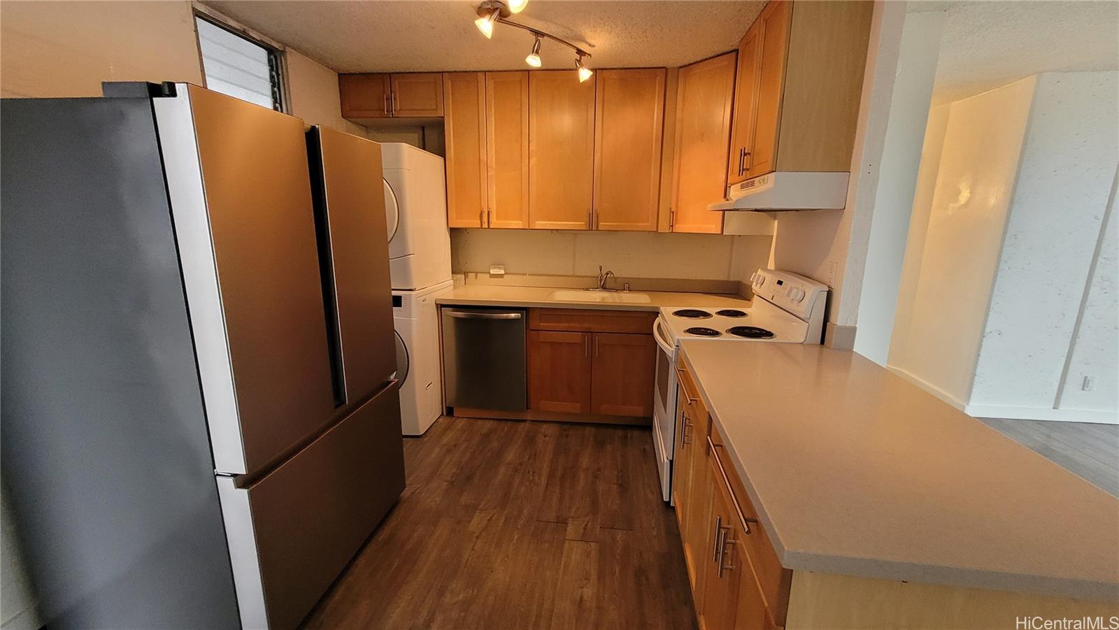 a kitchen with stainless steel appliances a refrigerator and a sink