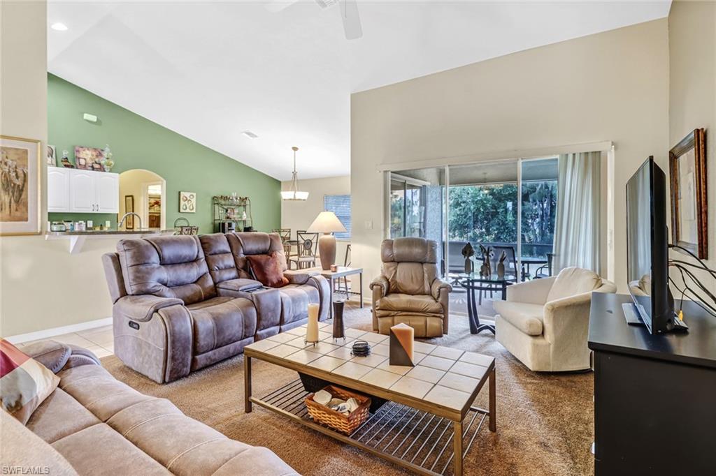 a living room with furniture large window and a table