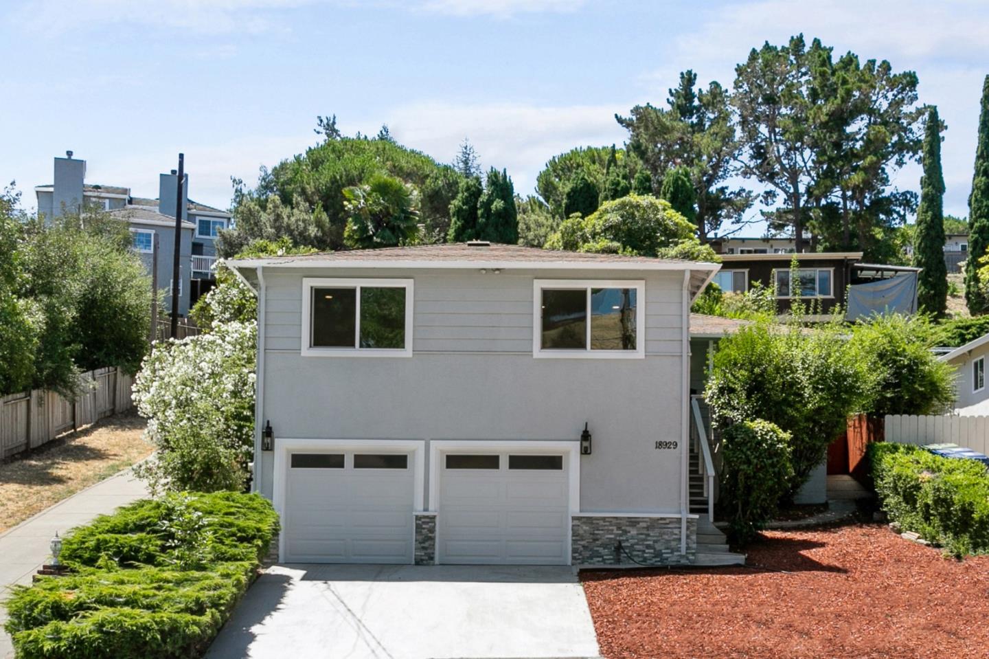 front view of a house with a garden