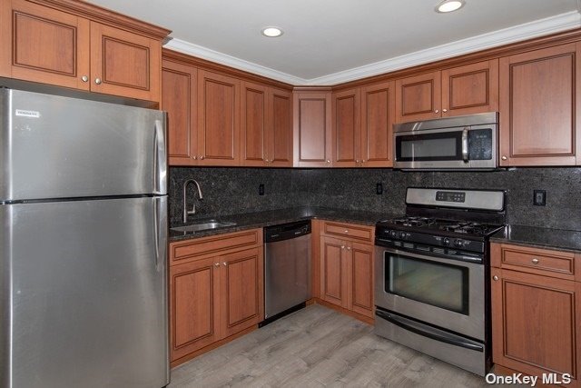 a kitchen with stainless steel appliances granite countertop a stove top oven a refrigerator a sink and dishwasher