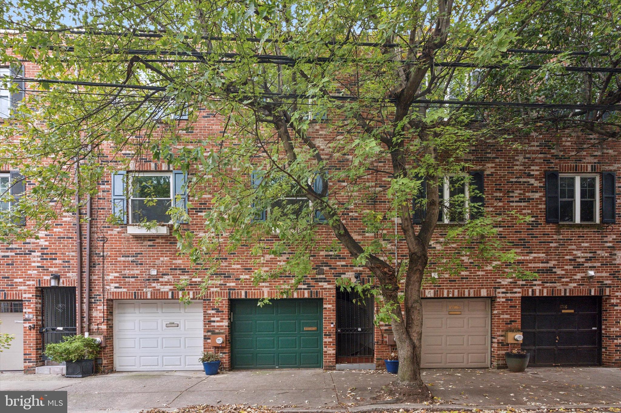 front view of a house with a tree