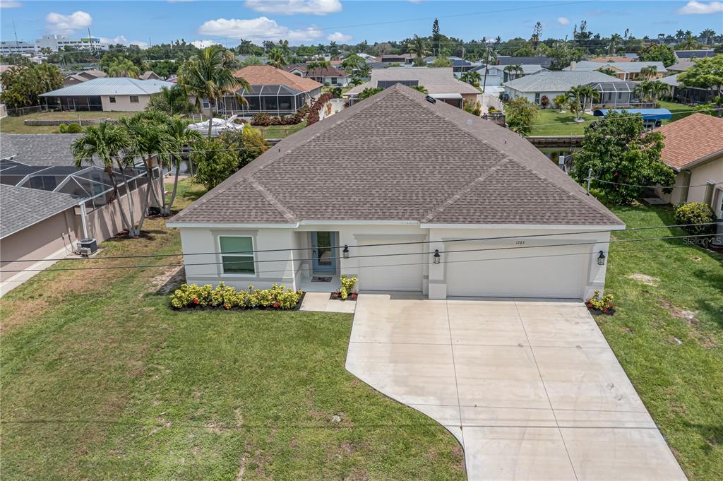 an aerial view of a house with a yard