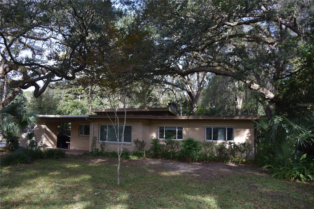 a front view of a house with a yard garage and outdoor seating