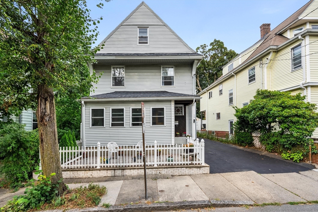 a front view of a house with a garden