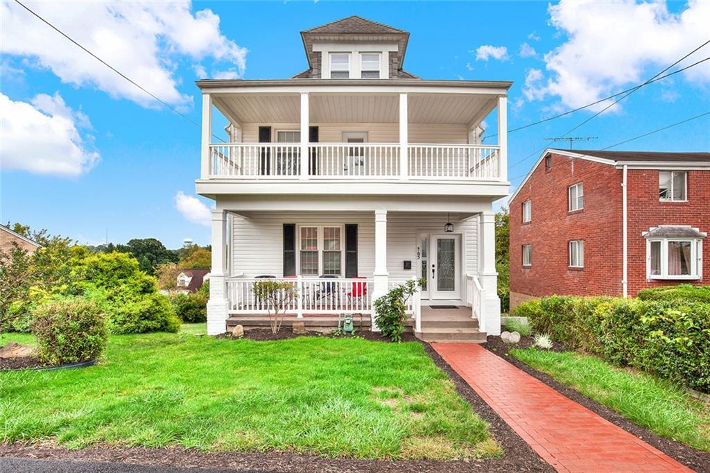 a front view of a house with a yard table and chairs