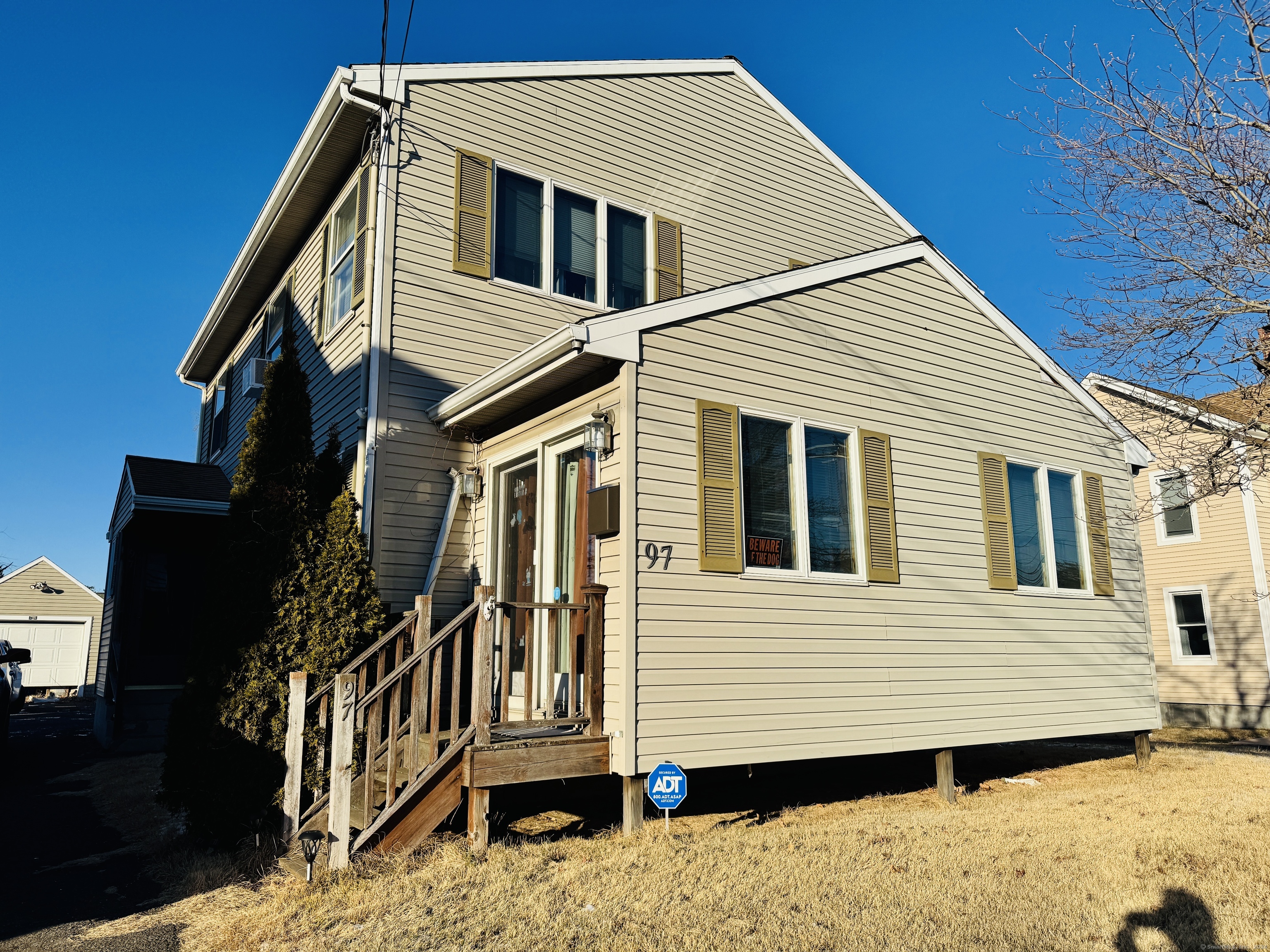 a view of a house with wooden fence