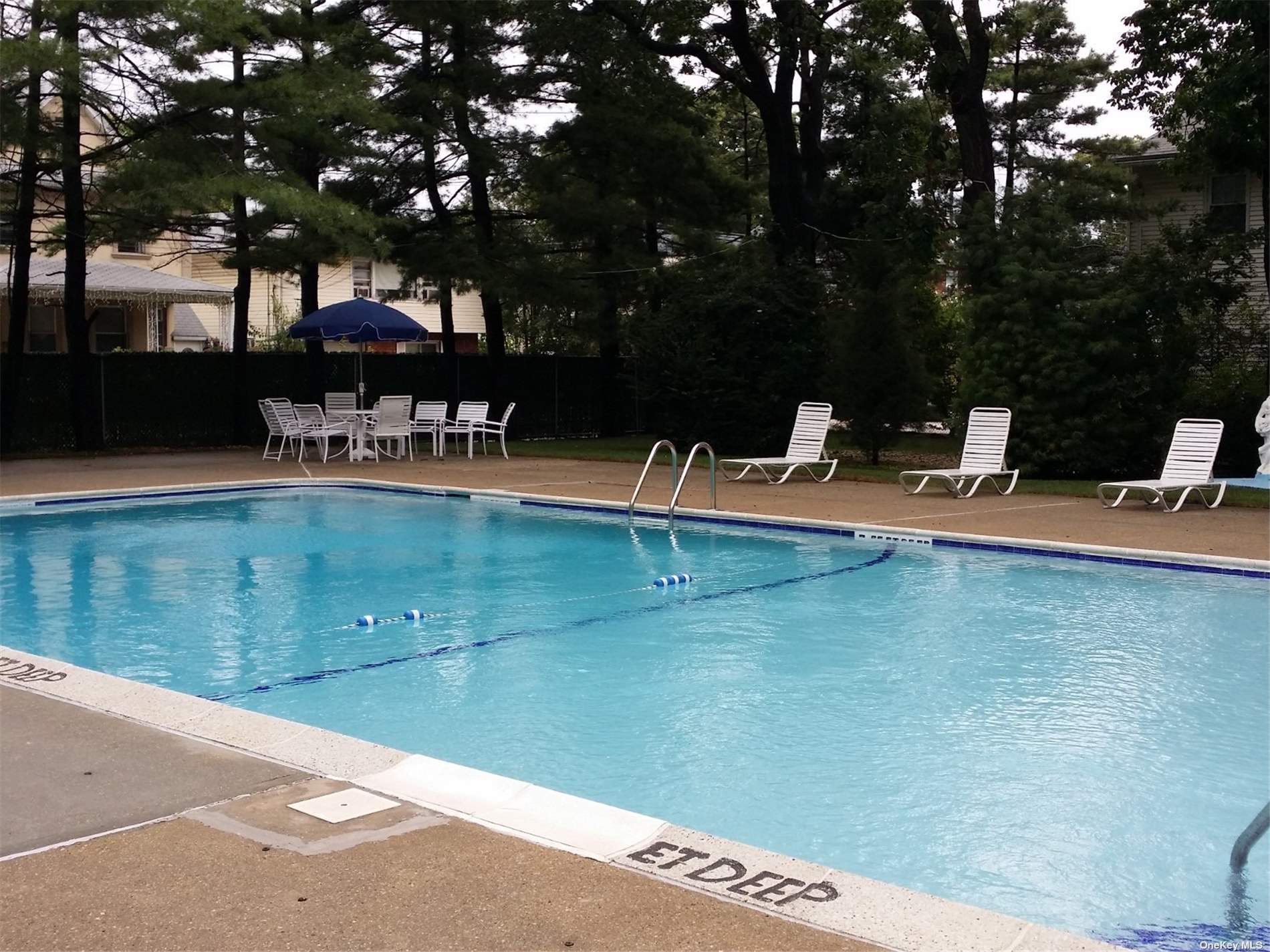 a view of a swimming pool with lounge chairs