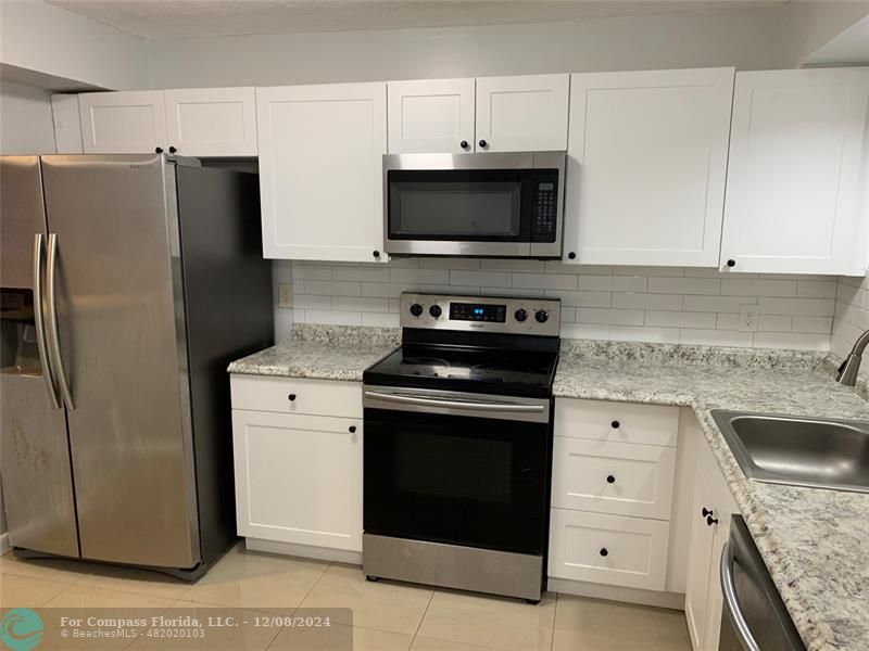 a kitchen with a stove microwave and refrigerator