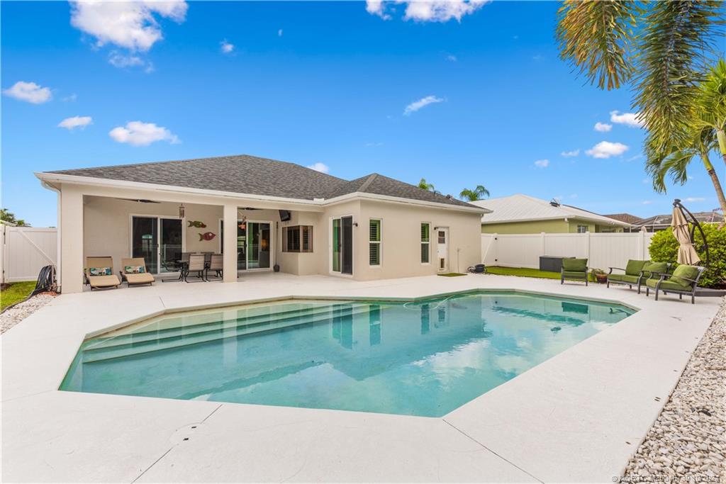 a view of a house with swimming pool and a yard