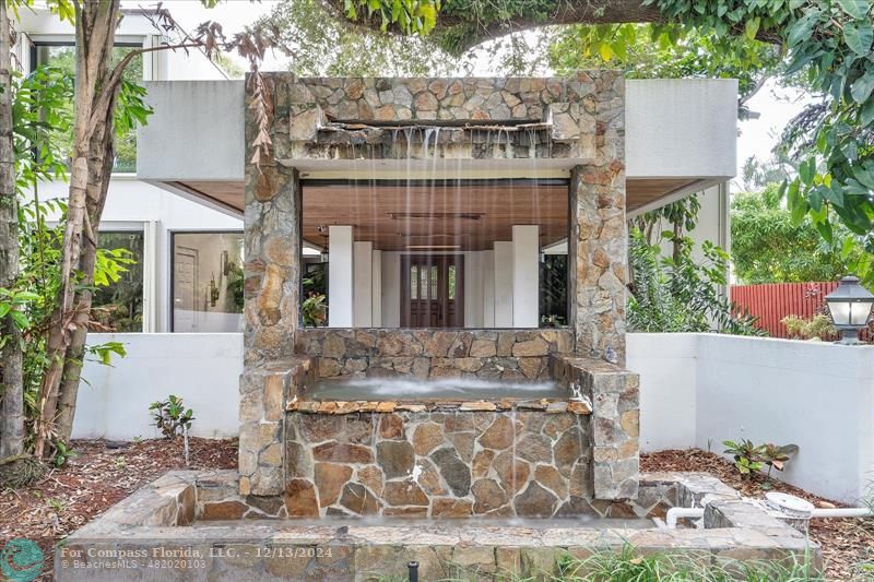 a front view of a house with plants