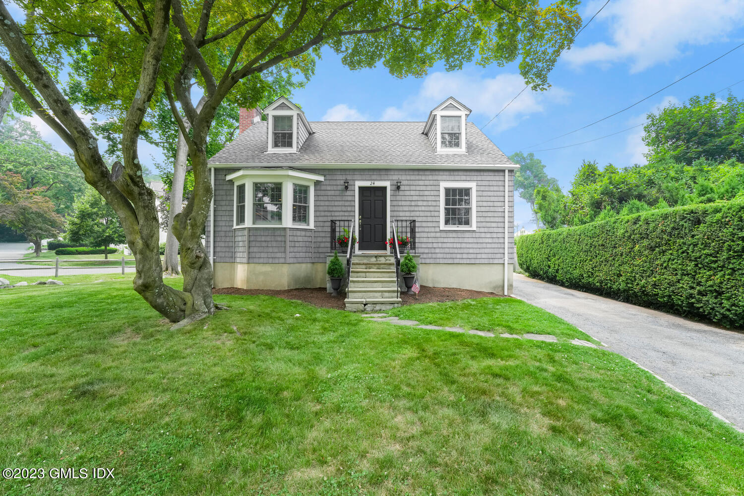 a front view of house with yard and green space