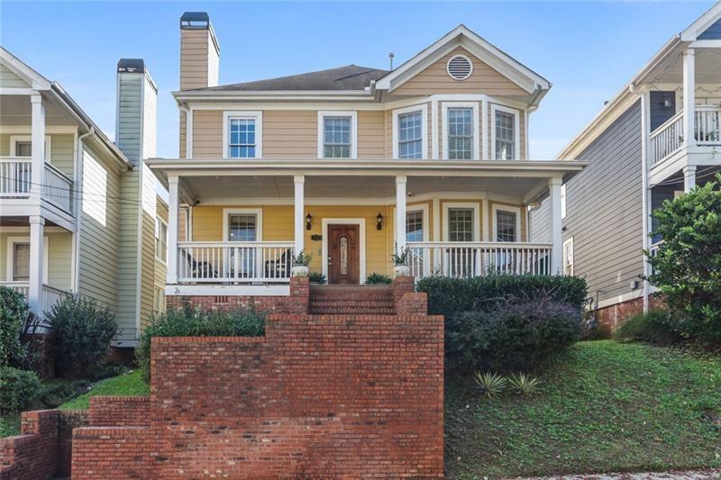 a front view of a house with garden and porch