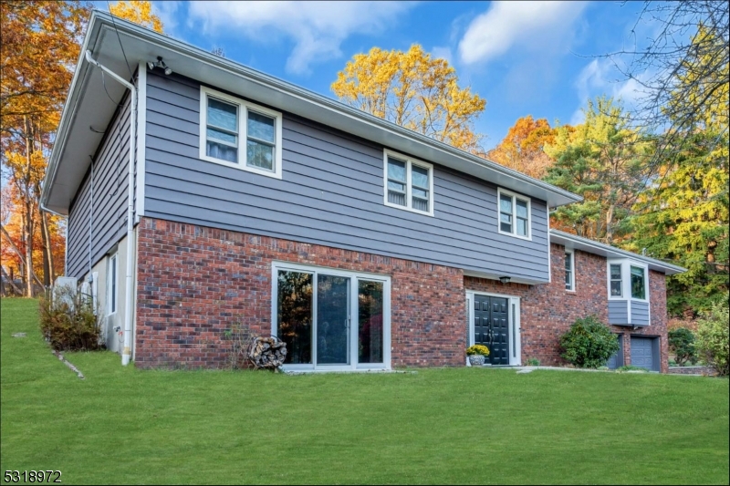 a view of a brick house with a yard