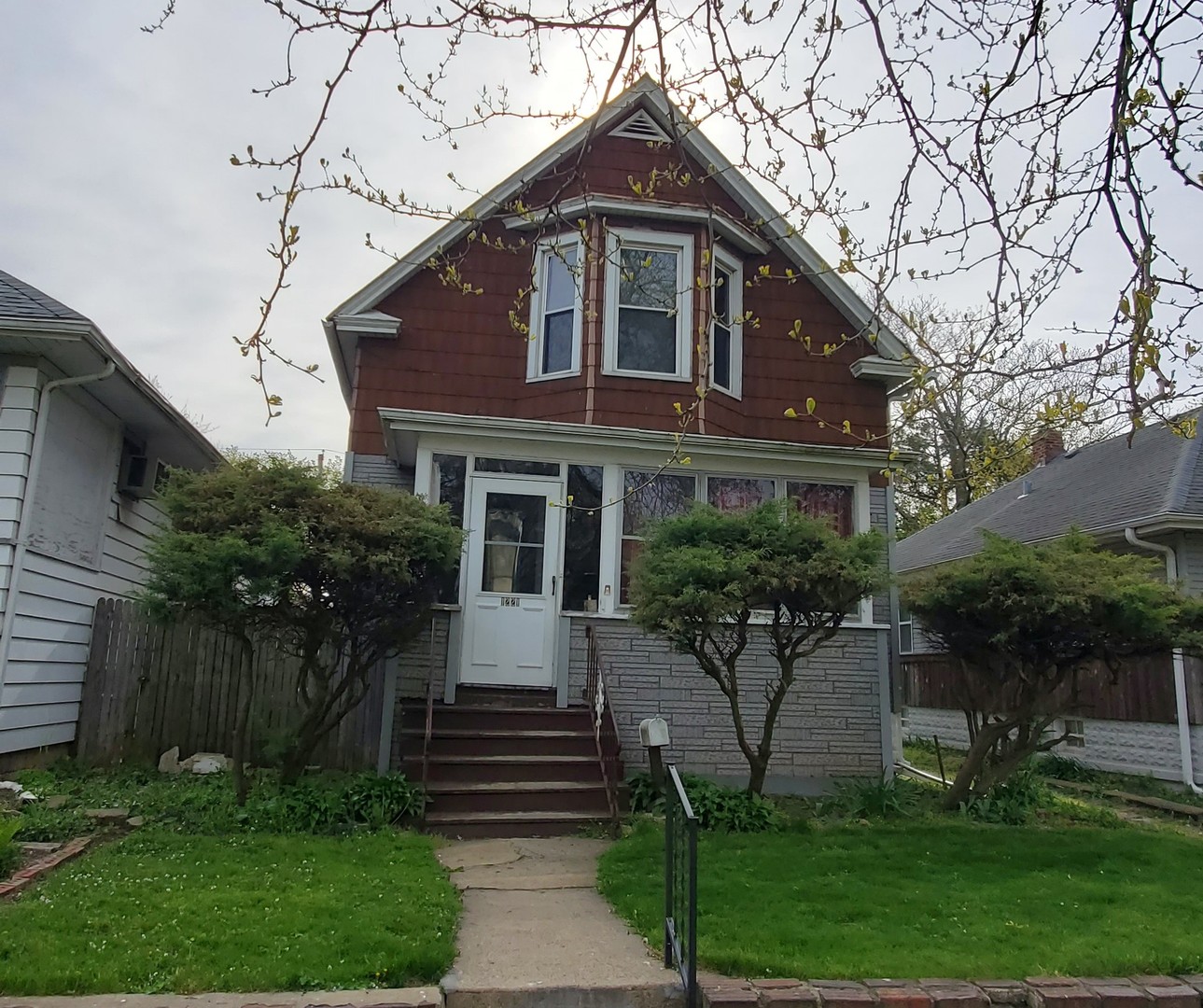 a front view of a house with a garden