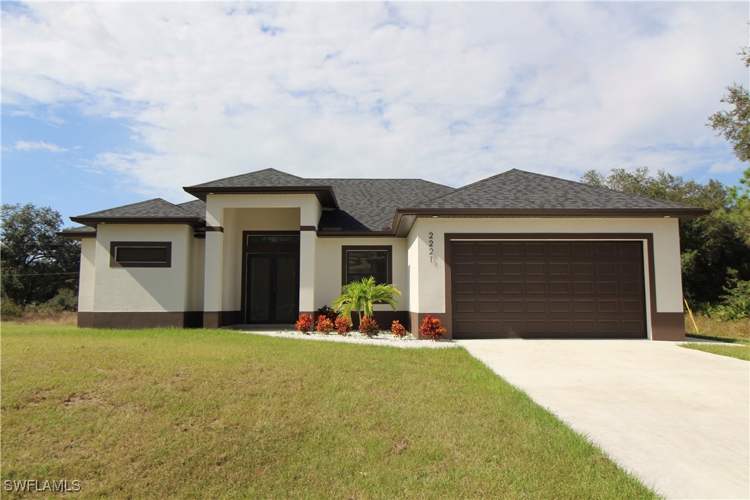 a front view of a house with a yard and garage