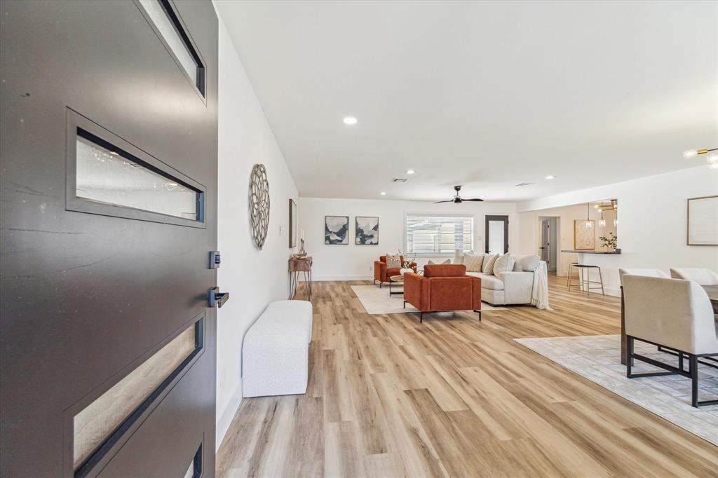 Welcome Home! A modern home with open-concept living space with wood like flooring, neutral walls, and contemporary finishes.