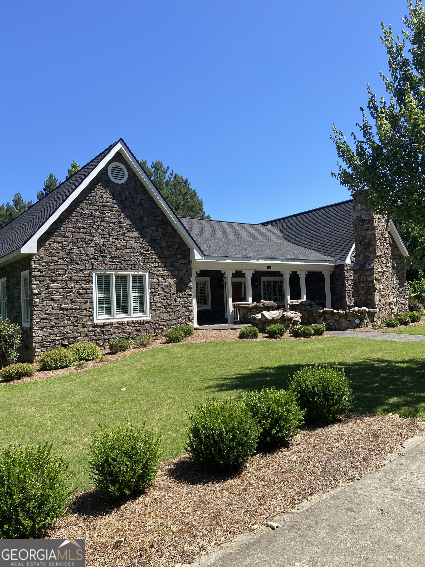 a front view of a house with a garden