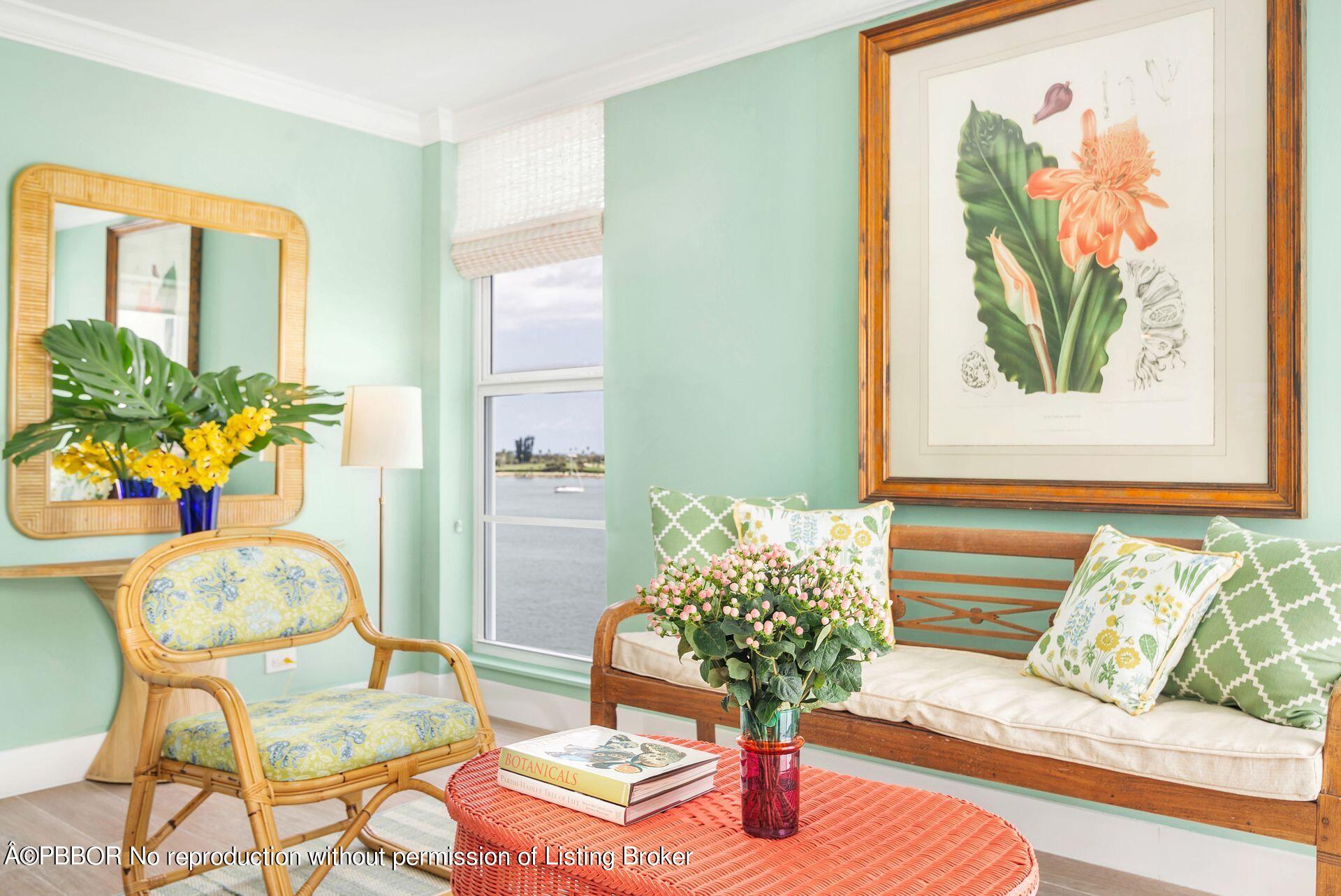 a living room with furniture and flowers