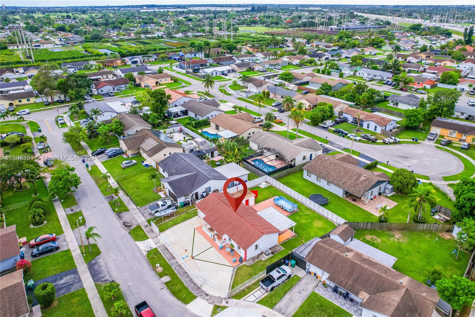 an aerial view of residential houses with outdoor space and street view