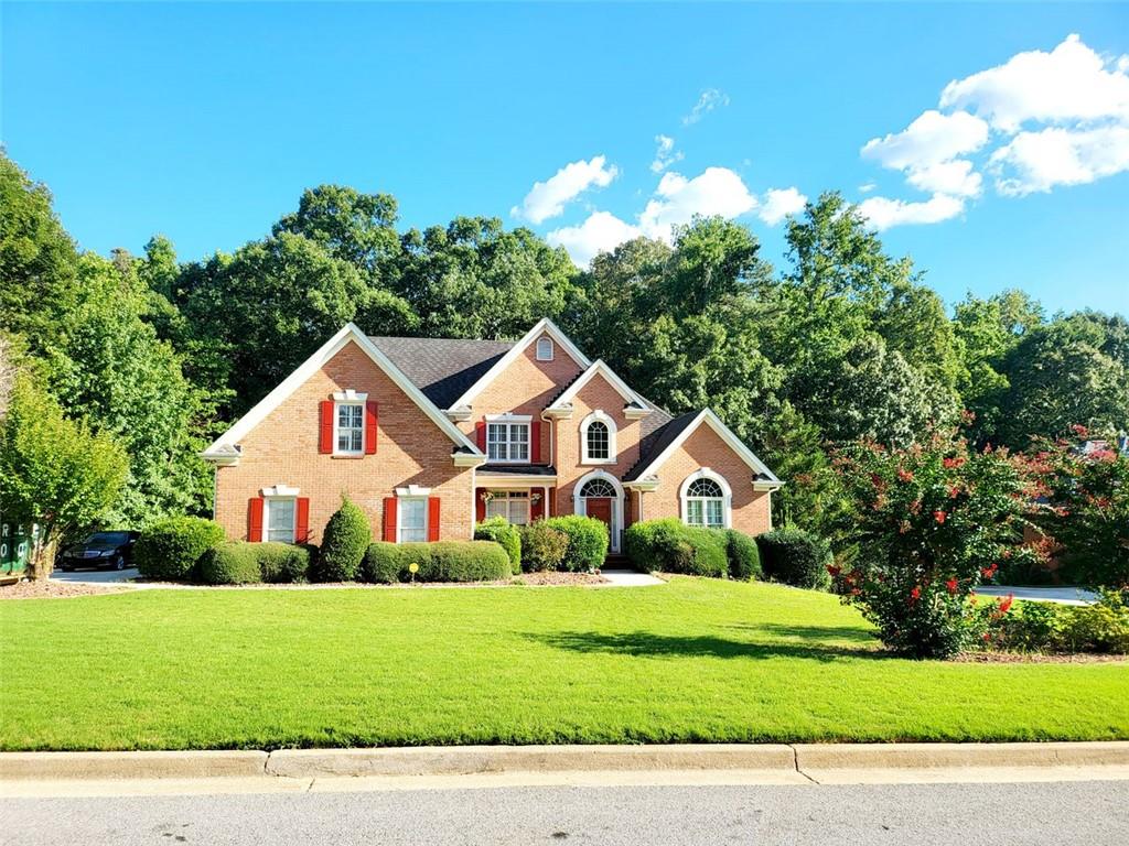 a front view of a house with a yard