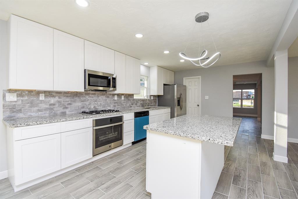 a kitchen with a sink stove and microwave