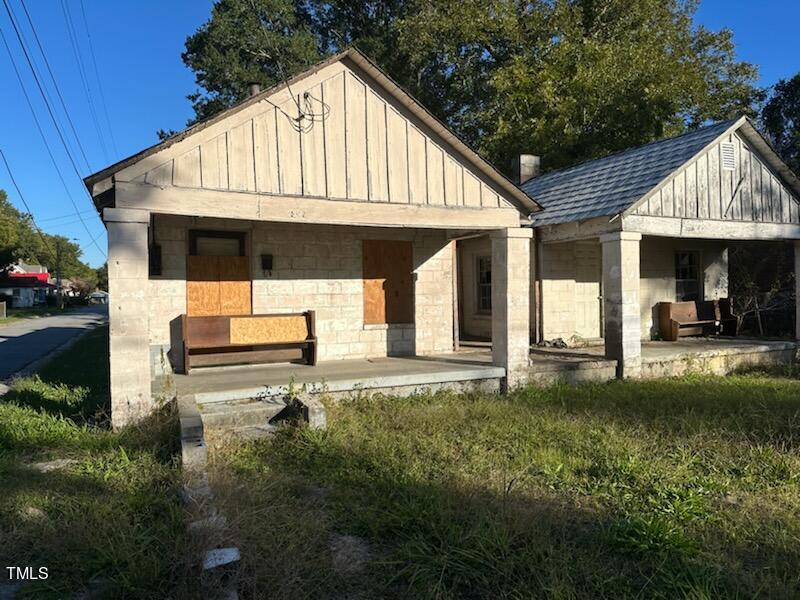 a backyard of a house with table and chairs