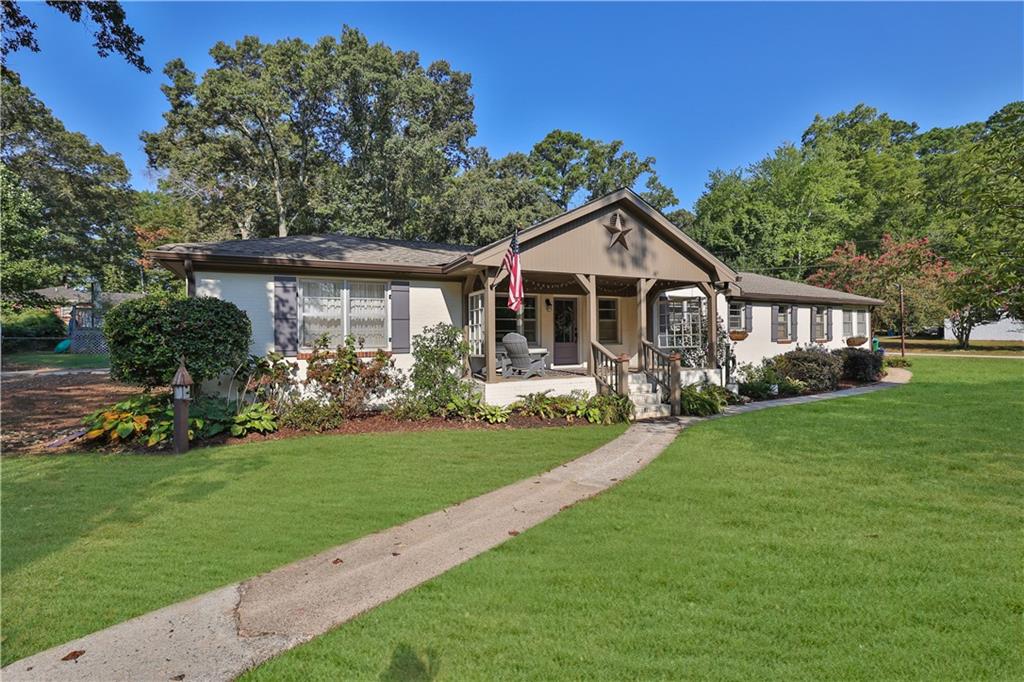 a front view of a house with a garden and yard