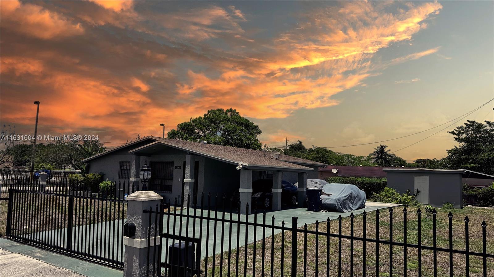 a view of a house with a wooden fence