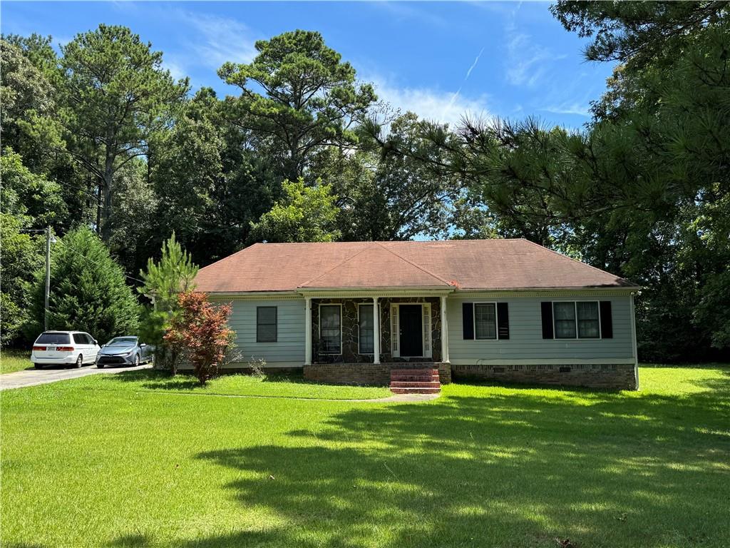 a front view of a house with a garden