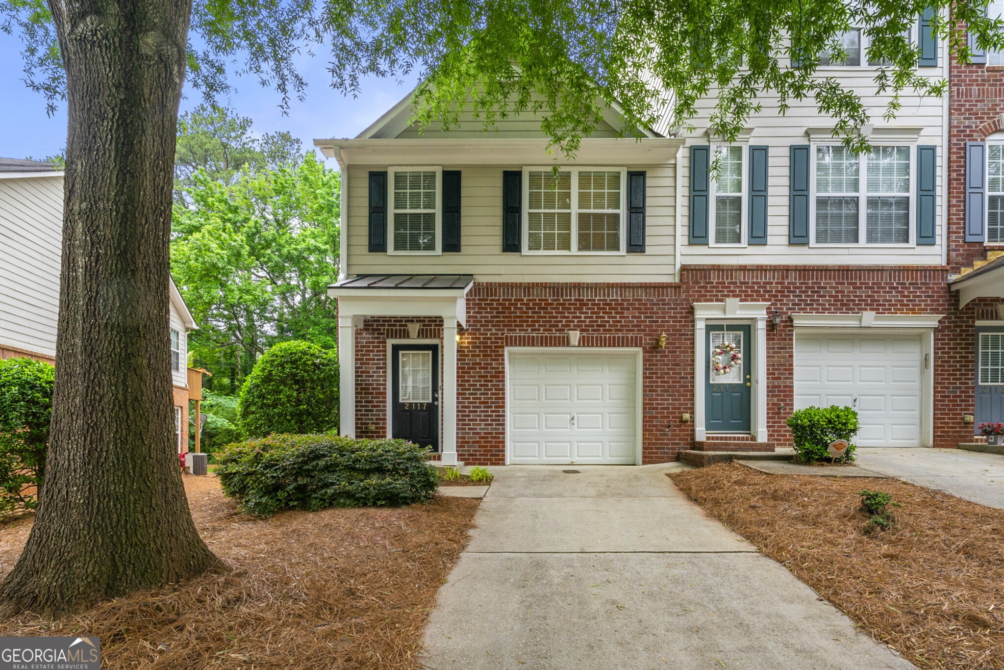 front view of a brick house with a yard