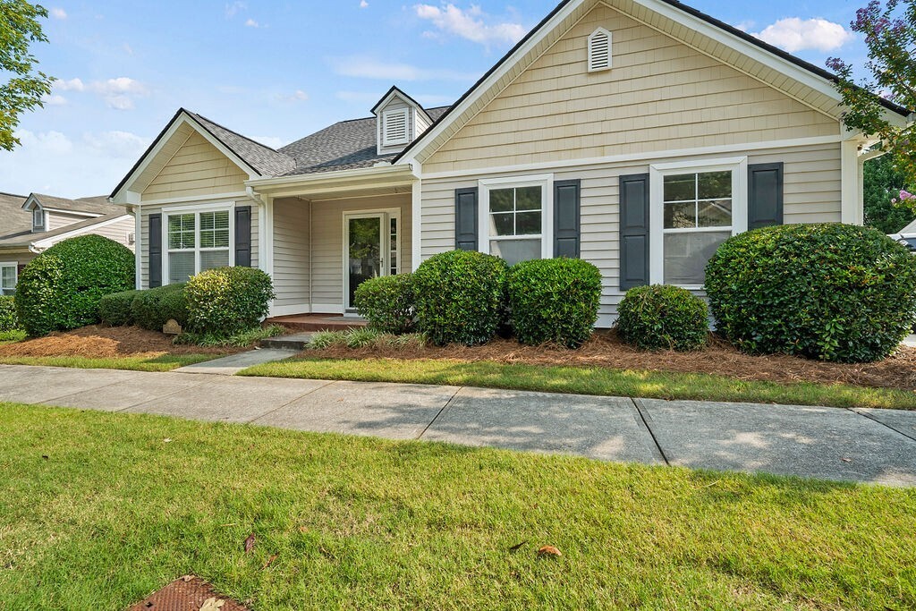 a view of a house with a yard and plants