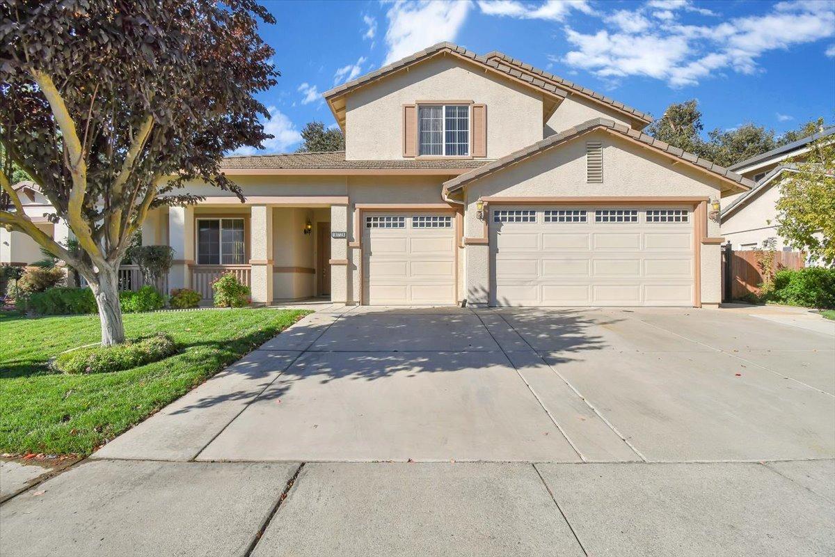 a front view of a house with a yard and garage