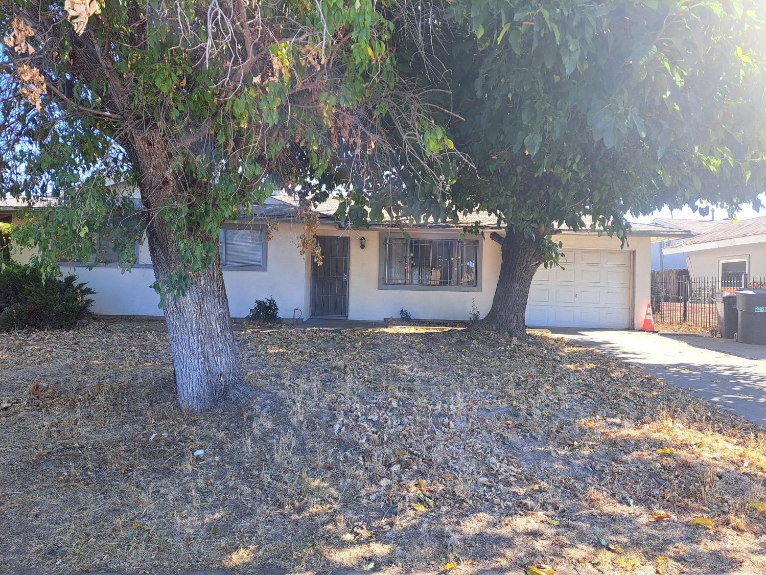 a view of a house with a yard and garage